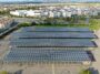 Aerial view of solar power plant installed on top of a parking lot. Renewable Energy: Solar Panels on the top of parking lot roof